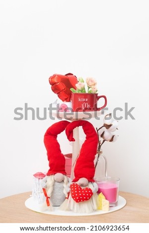 Home decorating ideas for Valentines Day. Candy bowl decorated with gnomes, cup, candles and gift boxes
