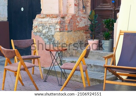 a cafe table on the summer terrace and four chairs