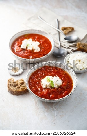 Homemade tomato soup with fresh cheese