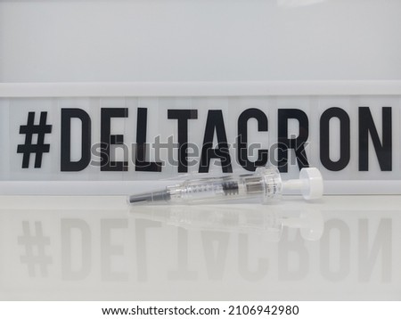 Deltacron. The new virus variant, a combination of Delta and omicron. Lightbox with the text "Deltacron" with a syringe in front