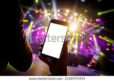 Using a smartphone at the concert hall. Empty blank screen