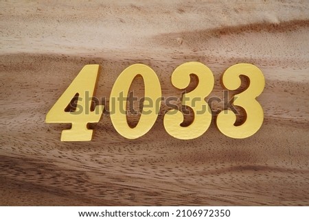 Golden Arabic numerals 4033 on a dark brown to white wood grain background.