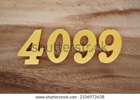 Golden Arabic numerals 4099 on a dark brown to white wood grain background.