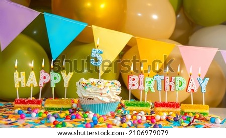 Cream cupcake with a candle for five years, Happy birthday colorful card for a child of 5 years old, birthday cupcake with candles and birthday decorations