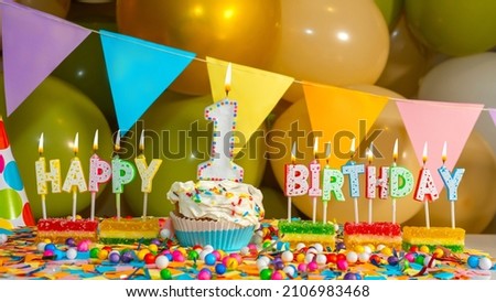 Cream cupcake with candle for one year, Happy birthday colorful card for 1 year old baby, birthday cupcake with candles and birthday decorations