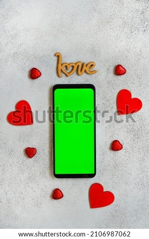 valentines day mock up cell phone, festive wooden decorations shape heart, green screen smart phone chroma key.