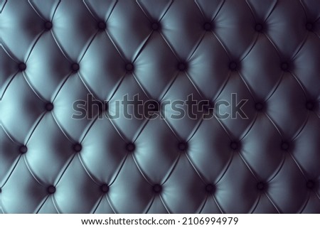 A view of the texture of a retro button tuft design, as a background.
