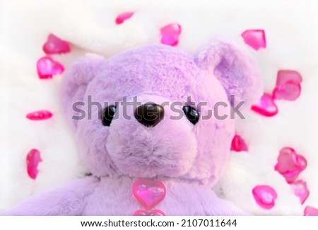 Cute teddy bear with hearts on white fluffy blanket. Valentines Day and love Concept
