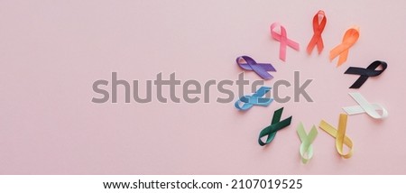 Multicolour ribbons on pink background, cancer awareness, World cancer day, world autism awareness day