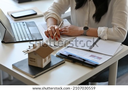 Top view with Real estate agent working with tablet and calculator for analyze business data, real estate, home loan, investment and insurance concept. Royalty-Free Stock Photo #2107030559