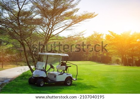 Golf carts line up in the golf course in the morning