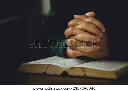 Man worship pray for god blessing to wishing have a better life. Man hands holding praying to god with the bible. christian life crisis prayer to god concept Royalty-Free Stock Photo #2107040846