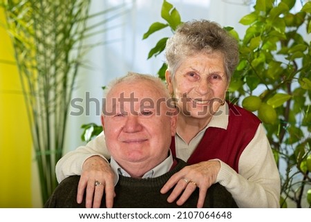 Picture of a joyful and happy elderly couple at home