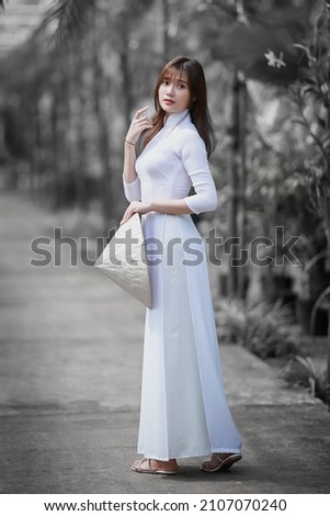 Ho Chi Minh City, Vietnam: Portrait women in white ao dai Vietnam, The Ao dai ( long-dress Vietnamese) is traditional costume of Vietnamese woman Royalty-Free Stock Photo #2107070240