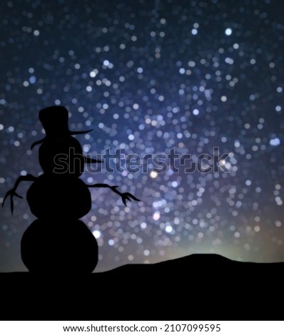 silhouette of a snowman in a hat, against the background of the bokeh of the starry sky. No foreground focus. The object in the foreground was drawn by me personally, so there is no reference