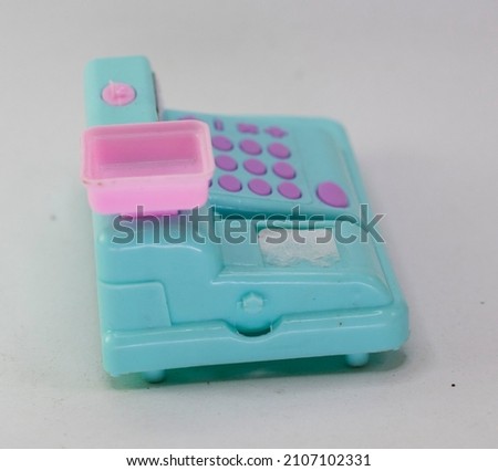 used children's toys in the form of a blue cash register. isolated in white.