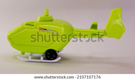 used children's toys, in the form of a green helicopter. isolated on white.
