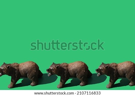 Figures of brown bears toys for children on green background