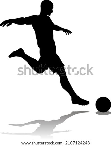 A soccer or football player in silhouette 