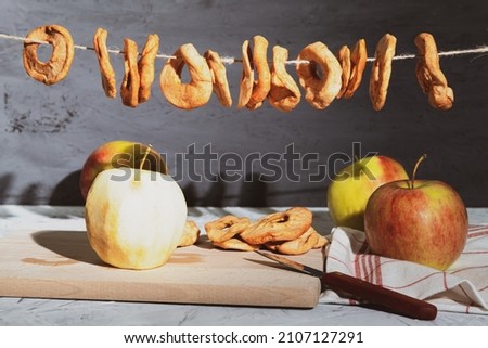 Dried apple fruits on a rope. Dried apples on a rope, Harvesting for the winter. Background with copy space