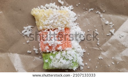 getuk lindri made from cassava with sugar and grated coconut on rice paper background. Getuk Lindri comes from Magelang, East Java. the concept of traditional snacks, old, snacks, culinary, symbol