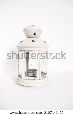 Gray lantern. Candlestick in the form of retro lamp. White candle holder. An isolated object on white background. Top view. Closeup.
