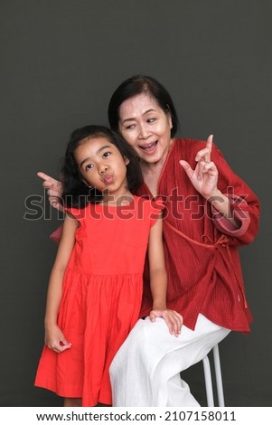 Grandma and Granddaughter taking picture together for birthday party