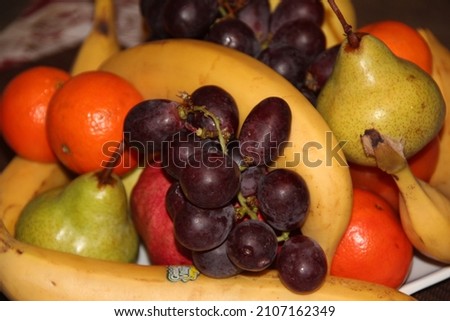 Fruit plate. Grapes, bananas, apples, citrus fruits