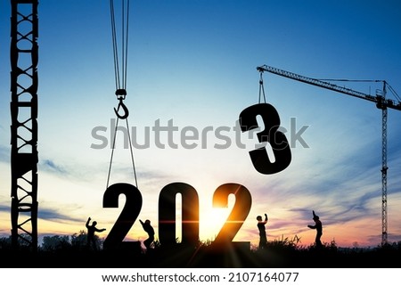 Silhouette of construction worker with crane and cloudy sky for preparation of welcome 2023 new year party and change new business.