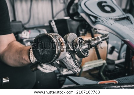 The mechanic go kart racing service pours fuel into the tank Royalty-Free Stock Photo #2107189763