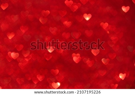Defocus light red Background. Hearts Bokeh with blick.