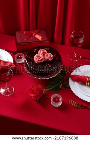 Romantic table setting with white dinnerware and red napkins, wine and candles. Valentines day or romantic dinner concept. Romantic Dinner. Royalty-Free Stock Photo #2107196888
