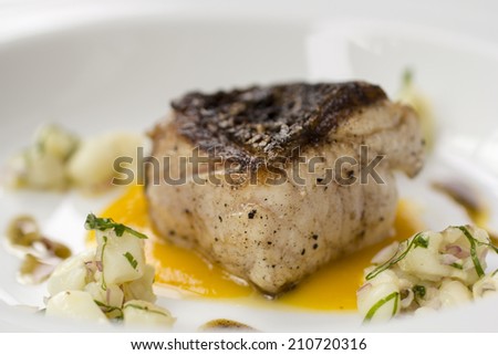Gourmet grilled fish fillet and orange sauce