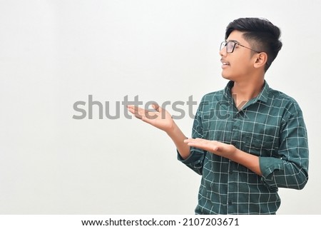 Young indian man showing direction with hand.