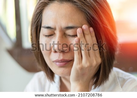 TMD and TMJ healthcare concept: Temporomandibular Joint and Muscle Disorder. Asia man hand on cheek face as suffering from facial pain, mumps or toothache Royalty-Free Stock Photo #2107208786