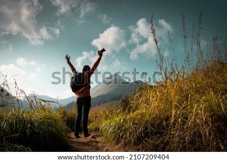 Landscape photographer enjoying view at mountains, amazing nature view from Chembra Peak Wayanad, Kerala  Travel and Tourism Image, The World Photography Day concept image Royalty-Free Stock Photo #2107209404