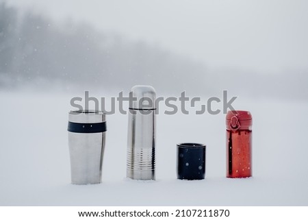A set of thermoses of different sizes and shapes. Dishes for hot drinks. Tourist tableware made of metal. High quality photo