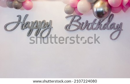 Photo zone with the inscription Happy Birthday and decoration of balloons