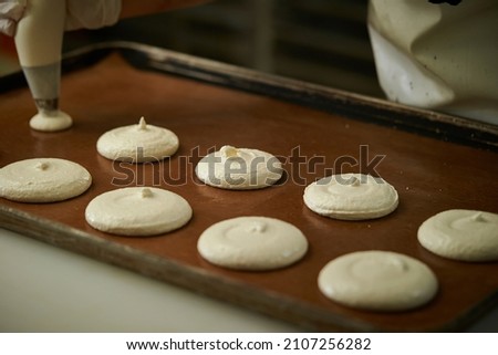 Making macarons, meringue close-up in the oven	
