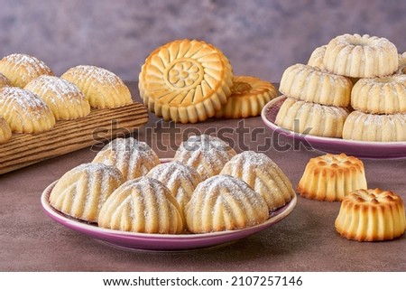 Assorted semolina maamoul or mamoul cookies with dates , walnuts and pistachio nuts. Traditional arabic Eid al Adha, Eid al Fitr sweets. Close up
