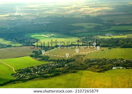 Aerial view of green field, position point and boundary line to show location and area. A tract of land for owned, sale, development, rent, buy or investment. Royalty-Free Stock Photo #2107265879