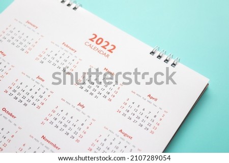 2022 calendar page on blue background business planning appointment meeting concept Royalty-Free Stock Photo #2107289054