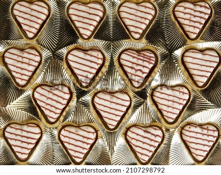Background of delicious sweets in the shape of hearts .