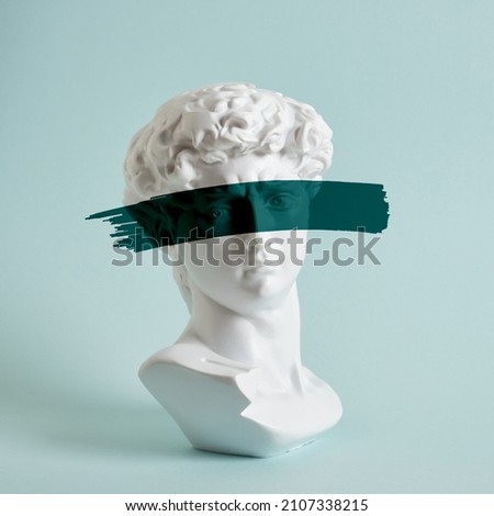 bust of david replica on a light blue background copy space, a copy of the work of michelangelo, art with antique sculpture Royalty-Free Stock Photo #2107338215