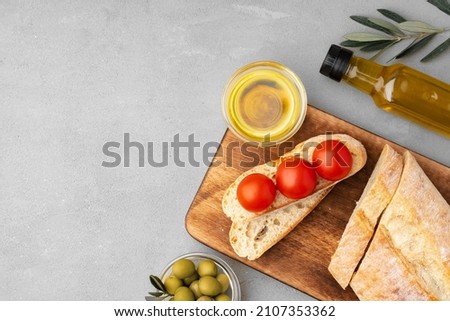 Italian ciabatta bread with olive oil on wooden background