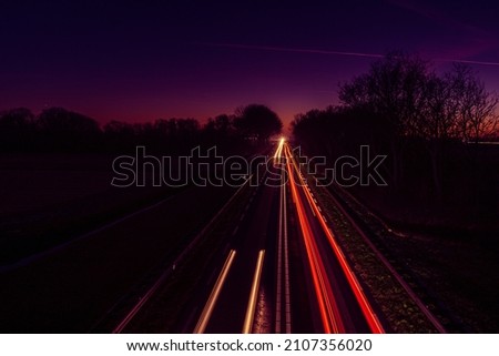 Long exposure of traffic on the road causes it to show as  light rays in the picture.