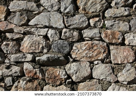 Stonewall. A stone wall made using concrete. Close up background. Royalty-Free Stock Photo #2107373870