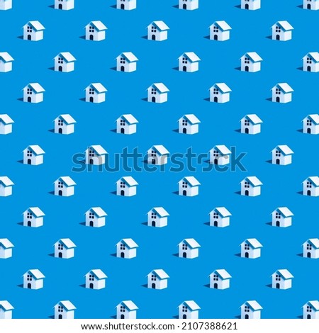 Seamless pattern with toy houses on a blue background. Pattern on the theme of real estate. Rent apartments, Real Estate and buying a house idea. 