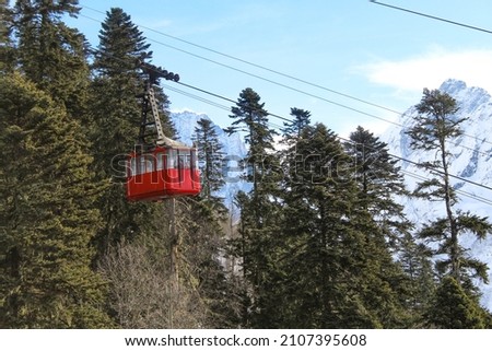 Cable car to the top of Dombay-Ulgen mountain. Caucasian ridge. Cableway to the mountains. North Caucasus. Snow-capped mountains of the Caucasus. Royalty-Free Stock Photo #2107395608
