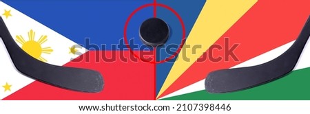 Top view hockey puck with Philippines vs. Seychelles command with the sticks on the flag. Concept hockey competitions